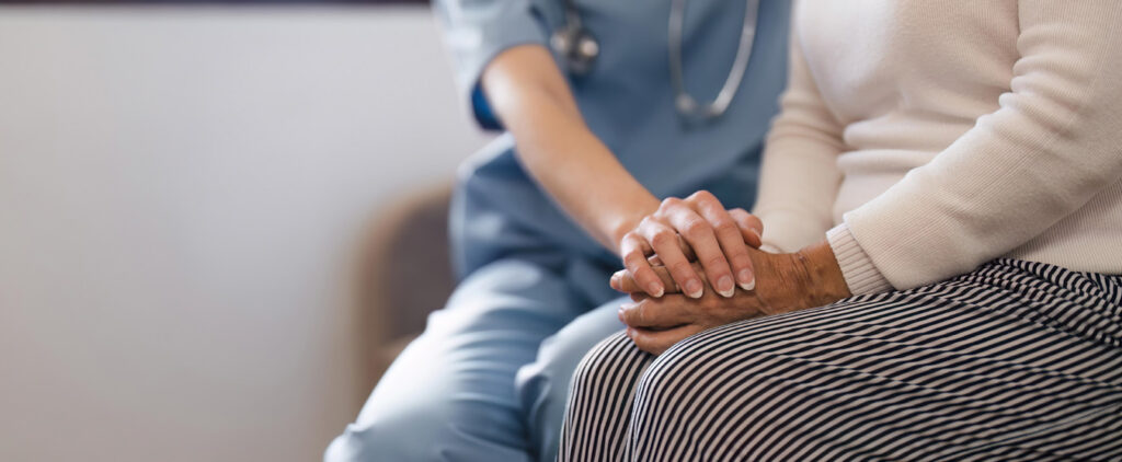 Nurse holding senior's hands
